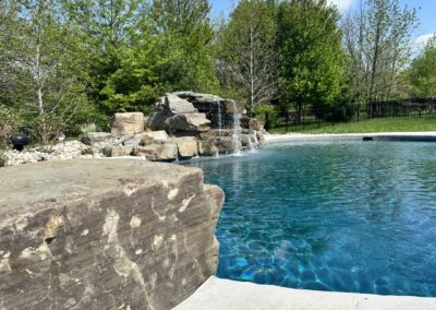 Free form pool, waterfall, jump rock