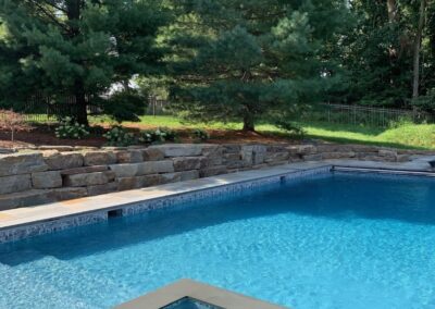 Swimming pool with spa, boulder wall