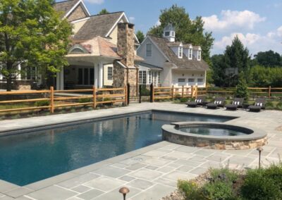 Swimming pool, raised stone spa, sunshelf