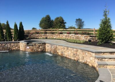Raised spa, wall and waterfall